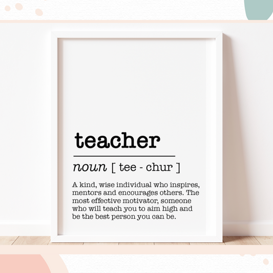A framed print with definition of a teacher in dictionary style inside